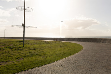 Front view of lampposts on the coast line against blue sky