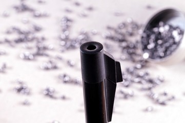 Air rifle barrel and a selection of pellets. Close up of a air gun. selective focus. gun control...
