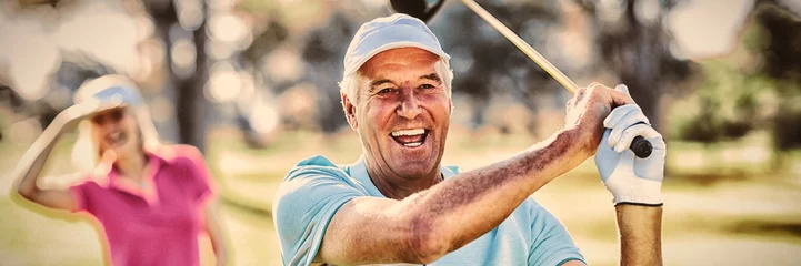 Papier Peint photo Golf Portrait of mature golfer holding golf club
