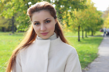 girl walking in the park in autumn