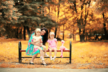 Mom with two daughters twins autumn