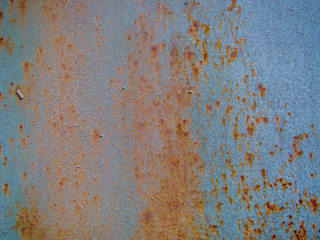 Metal wall with old blue paint. Lot of rust.
