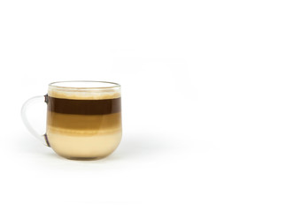 coffee with milk layers in a glass cup on a white background