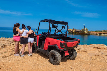 Obraz premium Pathos. Cyprus. Girlfriends on vacation in the Mediterranean. Remains of the ship off the coast of Cyprus. Women next to the ATV. Sights of the city of Paphos. View of the ship after the disaster. UTV