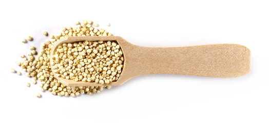 Organic quinoa seeds in wooden spoon isolated on white background, top view