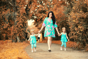 Mom with two daughters twins autumn