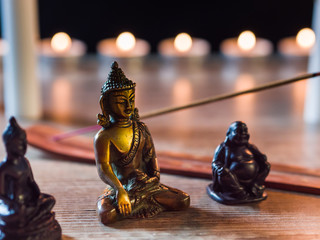 a Buddhist atmosphere with candles and incense