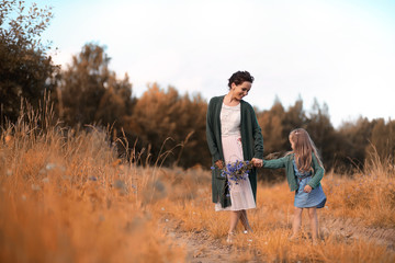 Mother with daughter walking on a road