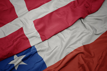waving colorful flag of chile and national flag of denmark.