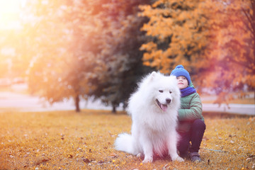 Fototapeta na wymiar Lovely girl on a walk with a beautiful dog