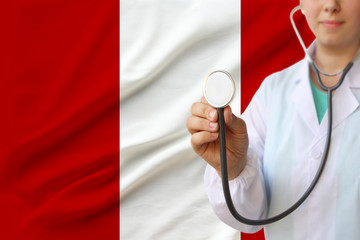 partial photograph of a girl doctor, nurse with a stethoscope in uniform against the background of...