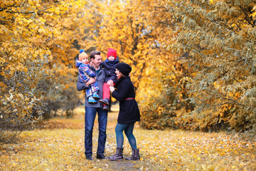 Family in autumn park in the afternoon