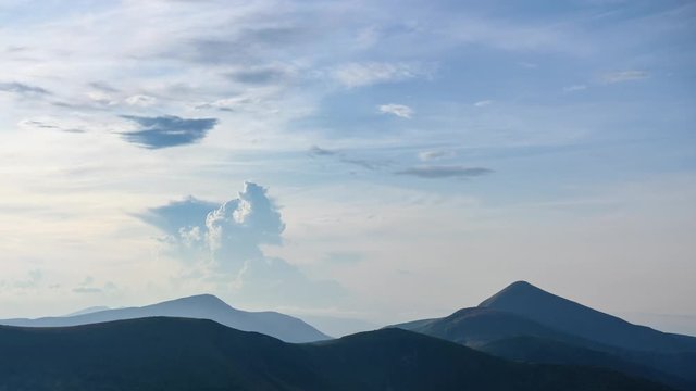 Mountain landscape timelapse footage. Moving clouds over green summer mountain ridge