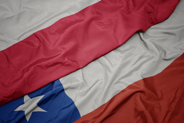 waving colorful flag of chile and national flag of poland.