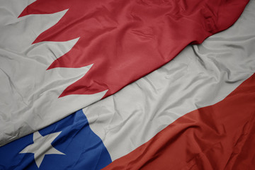 waving colorful flag of chile and national flag of bahrain.