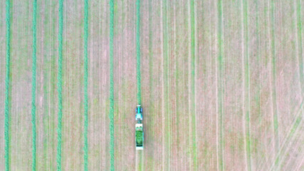 Ariel view of a modern new combine harvester cutting crops. Modern new tractor green combine...