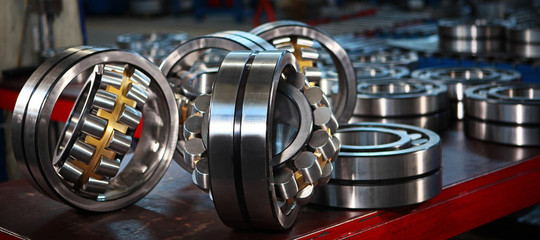 Production of bearings at the factory. Chrome plated surface. Industrial theme.Photos at the factory.Banner - obrazy, fototapety, plakaty
