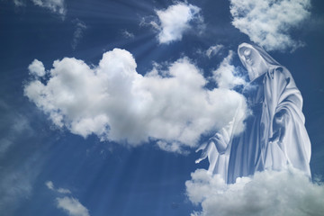 Mary in white clouds with light ray from  heaven.  © Phaitoon