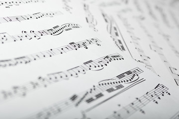 Sheets with musical notes closeup as a background