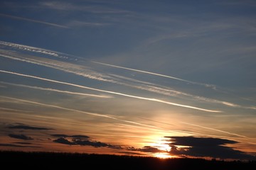 Stunning sunset with air traffic lines on sky