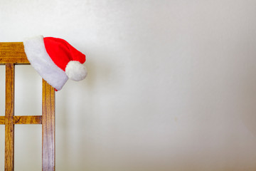 Santa Claus hat hanging on chair with copy space