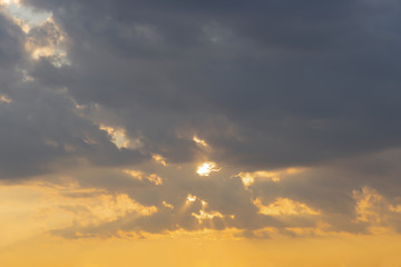 Naklejka na ściany i meble Beautiful sky, dawn, the rays of the sun break through the clouds. Natural background.