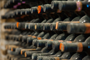 old wine bottles covered with dust and cobwebs are in the wine cellar