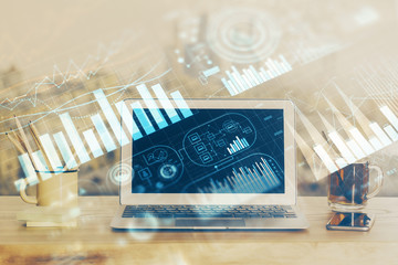 Stock market graph on background with desk and personal computer. Double exposure. Concept of financial analysis.