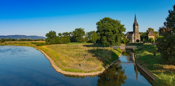 St Sturmius Church and meadow along river Weser. Rinteln, Germany