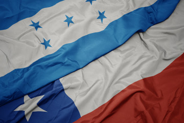 waving colorful flag of chile and national flag of honduras.