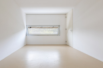 Large empty room with window looking nature and Swiss hills