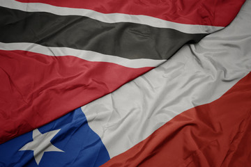 waving colorful flag of chile and national flag of trinidad and tobago.