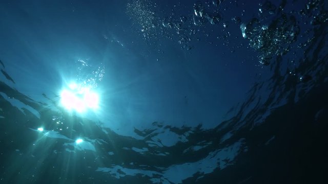 Sunlight under water surface with air bubbles, natural underwater scene, Mediterranean sea, Costa Brava, Spain