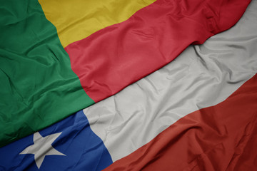 waving colorful flag of chile and national flag of benin.