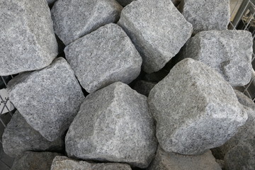 Granite stones for natural stone paving in the building materials trade for sale, close-up