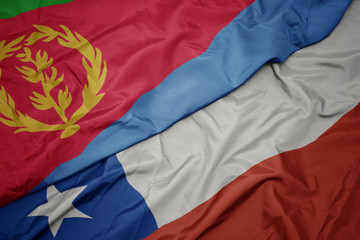 waving colorful flag of chile and national flag of eritrea.