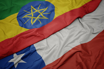 waving colorful flag of chile and national flag of ethiopia .