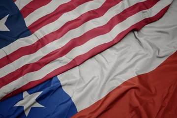 waving colorful flag of chile and national flag of liberia.