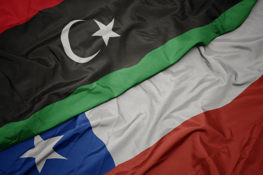 waving colorful flag of chile and national flag of libya.