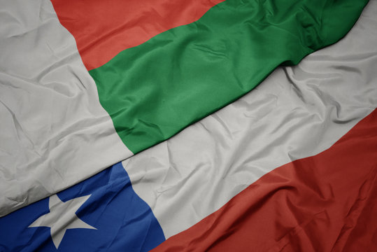 waving colorful flag of chile and national flag of madagascar.