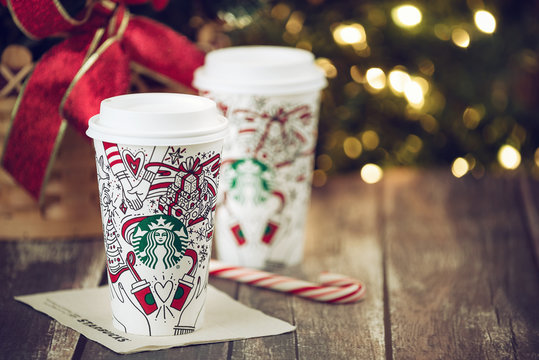 Starbucks popular holiday beverage displayed with candy canes against Christmas tree background on November 4, 2017 in Dallas, Texas.	