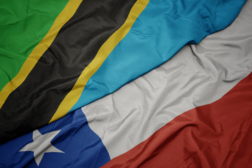 waving colorful flag of chile and national flag of tanzania.