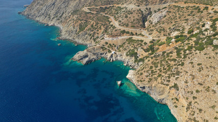 Aerial drone photo of iconic small chapel of Agia Anna built just above emerald rocky pebble beach, Amorgos island, Cyclades, Greece