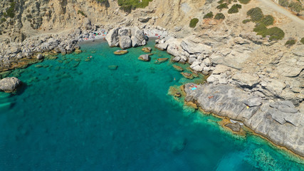 Aerial drone photo of iconic small chapel of Agia Anna built just above emerald rocky pebble beach,...