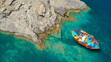 Aerial drone photo of iconic small chapel of Agia Anna built just above emerald rocky pebble beach,...