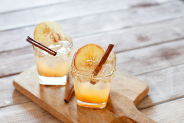 Apple cider cocktail with cinnamon and apple traditional autumn and winter drink