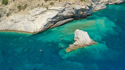 Aerial drone photo of iconic small chapel of Agia Anna built just above emerald rocky pebble beach,...