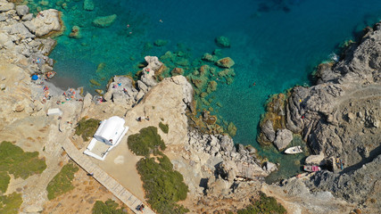 Aerial drone photo of iconic small chapel of Agia Anna built just above emerald rocky pebble beach, Amorgos island, Cyclades, Greece