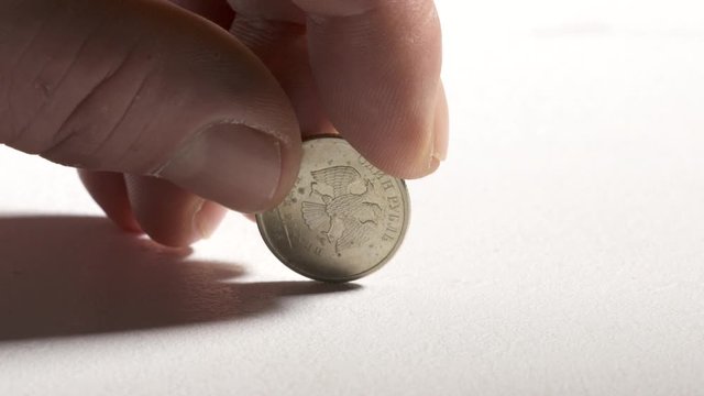 Hand holding 1 Russian ruble coin. One rouble currency of Russian Federation.
