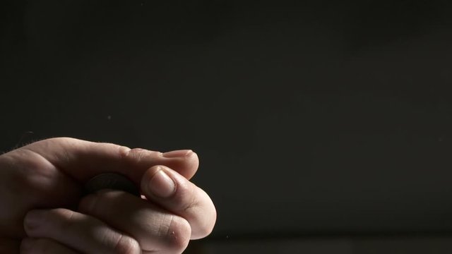 Hand tossing a coin. Throwing silver Deutsche Mark coin in the air close-up.
